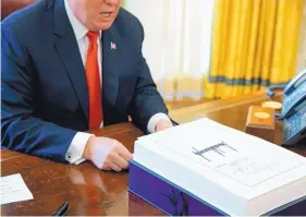  ?? ASSOCIATED PRESS ?? President Donald Trump speaks with reporters after signing the tax bill. Millions will be in uncharted waters as they tackle 2018 returns.