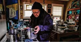  ?? Karen Warren/Staff file photo ?? Bill Weinle boils water to add heat in his Heights home on Feb. 17, 2021.