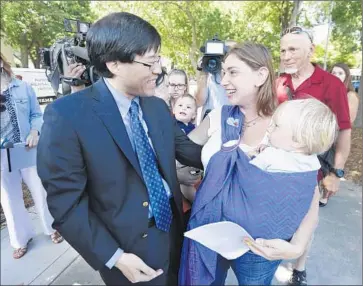  ?? Rich Pedroncell­i Associated Press ?? STATE SEN. Richard Pan (D-Sacramento) with Leah Russin and her son, Leo, in June after Gov. Jerry Brown signed Pan’s measure requiring nearly all California schoolchil­dren to be vaccinated.