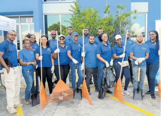  ??  ?? The Kingston Wharves Limited team members pose for the lens as they get ready to start their clean-up of sections of the Newport West community as part of Internatio­nal Coastal Clean-up Day.