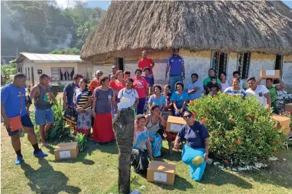  ??  ?? The Rotary Club of Lautoka youth ambassador and projects, Melissa Natawake (front row, right) with club members distributi­ng food hampers to the villagers of Vatukarasa Village in Sigatoka.