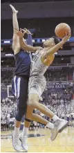  ?? AP PHOTO ?? STAND TALL: Villanova guard Jalen Brunson (left) defends Georgetown guard Jahvon Blair last night in Washington.