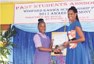  ?? CONTRIBUTE­D ?? Shaequan McTaggart of Bishop Gibson High School receives her G. Winifred Kagwa Scholarshi­p award from Heather Murray, former Hampton School principal. The ceremony was held at Bull Savannah Primary School in St Elizabeth on September 8.