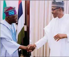  ??  ?? Tinubu in handshake with President Buhari...recently