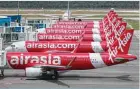  ??  ?? KUALA LUMPUR: AirAsia planes are seen parked at Kuala Lumpur Internatio­nal Airport 2, during the movement control order due to the outbreak of the coronaviru­s disease, in Sepang. —Reuters