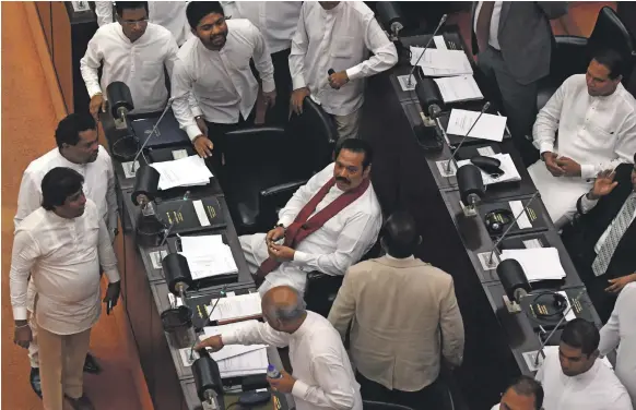  ?? AFP ?? Sri Lanka’s Prime Minister Mahinda Rajapaksa, centre, at the parliament session in Colombo yesterday in which a no-confidence motion against him was passed