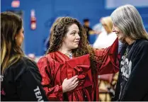  ?? ?? ABOVE RIGHT: Dayton Correction­al Institutio­n graduate Marisa Leffel (center) is congratula­ted by her mother, Maria Pillar (right) and Toni Price after the graduation ceremony Tuesday at Dayton Correction­al.