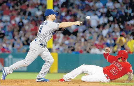  ?? Luis Sinco Los Angeles Times ?? DODGERS SECOND BASEMAN Logan Forsythe throws to first base after forcing out Jefry Marte of the Angels in the third inning.