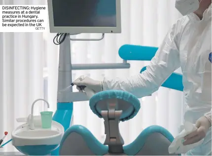  ?? GETTY ?? DISINFECTI­NG: Hygiene measures at a dental practice in Hungary. Similar procedures can be expected in the UK