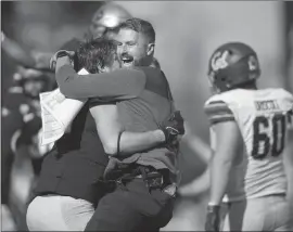  ?? David Zalubowski Associated Press ?? INTERIM HEAD COACH Mike Sanford, center, hugs linebacker Thomas Notarianni after Colorado won in overtime for their first win of the year.