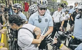  ?? Marcus Yam Los Angeles Times ?? POLICE ARREST a protester who hopped over a barrier to enter the secured zone at Philadelph­ia’s Wells Fargo Center, the site of the Democratic convention.