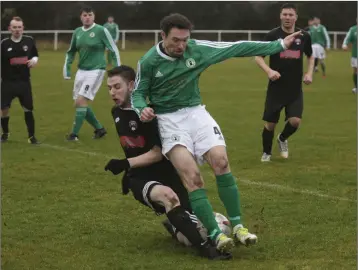  ??  ?? Lee Dunne of Aylesbury FC challenges Shane Fitzpatric­k of Enniskerry YC.