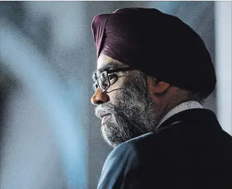  ?? SEAN KILPATRICK THE CANADIAN PRESS ?? Minister of National Defence Minister Harjit Sajjan takes part in a press conference on Canada's peacekeepi­ng mission to Mali in the foyer of the House of Commons on Parliament Hill in Ottawa Monday.