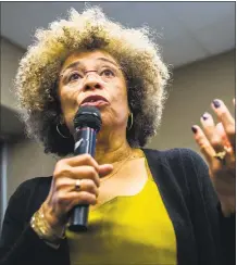  ?? Associated Press ?? In this 2015 file photo, Angela Davis, author, educator and iconic civil rights activist, speaks during her visit to the University of Michigan-Flint, in Flint, Mich. The Birmingham Civil Rights Institute in Alabama announced this month that it has rescinded its decision to honor Davis.