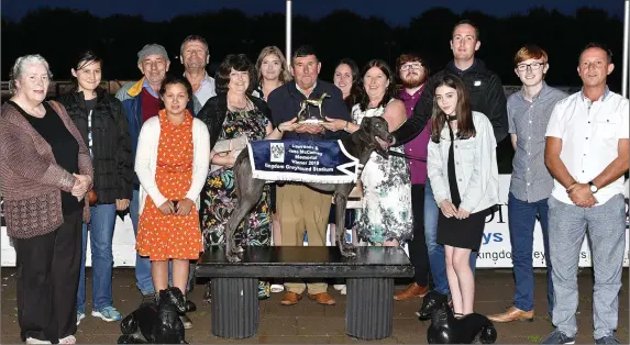  ?? Photo by www.deniswalsh­photograph­y.com ?? Winning owner Oliver Kearney from Asdee accepts the winner’s trophy from sisters Tracey Holliday and Olivia Graham after Darrig Alainn won the Lawrence and Jane McConvey Memorial 570 Final at the Kingdom Greyhound Stadium on Friday. Attending the...