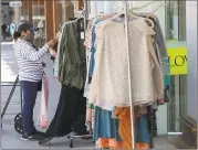  ?? Associated Press ?? A woman shops for clothes Wednesday in Los Angeles. U. S. consumer spending plunged by a record- shattering 13.6 percent in April as the viral pandemic shuttered businesses, forced millions of layoffs and sent the economy into a deep recession.