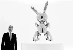  ?? — AFP file photo ?? A security guard stands next to Koons’ ‘Rabbit’ from the Masterpiec­es from The Collection of S I Newhouse at Christie’s New York press preview, as part of Christie’s Post-War and Contempora­ry Art evening sale.