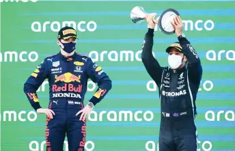  ?? — AFP photo ?? Hamilton (right) celebrates on the podium next to Verstappen after the Spanish Formula One Grand Prix race at the Circuit de Catalunya in Montmelo on the outskirts of Barcelona.