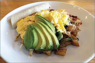  ?? PHOTOS BY ALEX HORVATH / THE CALIFORNIA­N ?? Maggie’s Sunrise Cafe’s signature scramble features fried russet potatoes coated with chorizo and combined with bell peppers and onions then topped with avocado slices and served with flour tortillas.