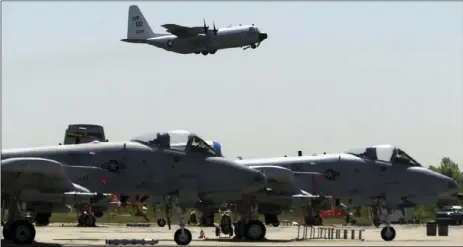  ??  ?? A-10’s from the 111th Fighter Wing are seen in the foreground as a U.S. Navy C-130 takes off from N.A.S. J.R.B. Willow Grove in Willow Grove Pa., on May 13, 2004. The A-10 attack plane has been given new life, spared by Air Force leaders who have...