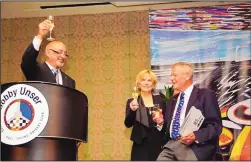  ?? ALBERT WONG/ROAD RACING DRIVERS CLUB ?? Bobby Rahal, left, toasts Lisa and Bobby Unser during a dinner in Unser’s honor by the Road Racing Drivers Club in Long Beach, Calif., on Thursday. The banquet was prior to the running of the Long Beach Grand Prix.