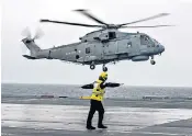  ??  ?? Capturing the action: out for six weeks of sea trials, Chris Terrill, below, was there to record every moment on board HMS Queen Elizabeth, including its first helicopter landing