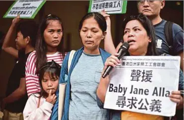  ?? PIC AFP ?? A picture taken on April 15, 2019, showing Baby Jane
Allas (centre), a Filipina domestic worker and mother of five who was sacked after she was diagnosed with cervical cancer, reacting after a hearing at the Labour Tribunal in Hong Kong.