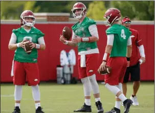  ?? NWA Democrat-Gazette/David Gottschalk ?? THREE DEEP: Razorback quarterbac­ks Austin Allen, from left, Cole Kelley and Ty Storey run through drills July 18 in Fayettevil­le. Arkansas begins the season Thursday, Aug. 31 against Florida A&M at Little Rock’s War Memorial Stadium.