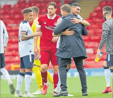  ??  ?? Smiles all round at Pittodrie as Steven Gerrard congratula­tes Leon Balogun on his debut