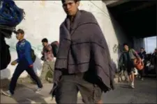  ?? RODRIGO ABD — THE ASSOCIATED PRESS ?? Central American migrants, part of the Central American caravan trying to reach the United States, continue their journey as they leave Mexicali, Mexico, Tuesday