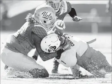  ?? Wally Skalij Los Angeles Times ?? UCLA LINEBACKER Jayon Brown, stopping Colorado running back Patrick Carr in the first quarter, led the injury-depleted Bruins defense with 18 tackles, a career high.