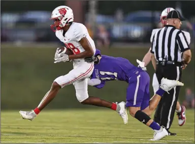  ?? (NWA Democrat-Gazette/Hank Layton) ?? Endy McGalliard (left) of Harding Academy catches a pass as Jace Washburn of Booneville pursues Friday during the first quarter of the Wildcats’ 44-14 win at Bearcat Stadium in Booneville. Visit nwaonline.com/220918Dail­y/ for today’s photo gallery.