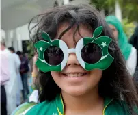  ??  ?? A girl wearing customised prop glasses adorned in the official flag colours of Pakistan during the celebratio­ns.