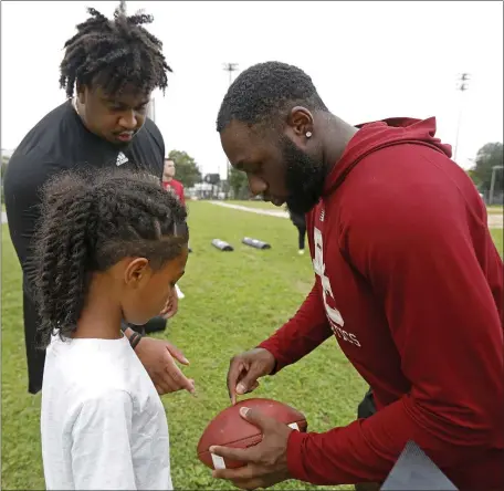  ?? PAUL CONNORS — BOSTON HERALD ?? The Boston Bengals held its last practice of the season at Clifford Playground in Roxbury on Saturday. The Pop Warner football program is merging with another that hosts children from Brookline and Jamaica Plain. A group of Boston College football players interacted with the Bengals Saturday.