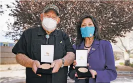  ?? GABRIELA CAMPOS/THE NEW MEXICAN ?? Tom Mirabal, left, holds a Congressio­nal Gold Medal for his late father, John Mirabal, and Margaret Garcia holds a medal for her later father, Evans Garcia, at the New Mexico Veterans Memorial in Albuquerqu­e on Thursday afternoon.