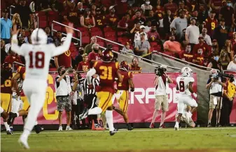  ?? Marcio Jose Sanchez / Associated Press ?? Stanford’s Nathaniel Peat (8) breaks free for an 87-yard touchdown run in the Cardinal’s win over USC at the L.A. Memorial Coliseum on Saturday night. Peat had nine carries for 122 yards.