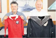  ?? ?? Mowbray Collectabl­es' Brendan Watson (left) and John Mowbray, with a Welsh and All Blacks jersey from 1905.