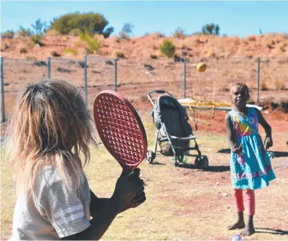  ?? ?? Kids at play in the remote community of Titjikala, 120km south of Alice Springs. Picture: Lucy Hughes