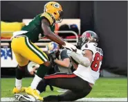 ?? (AP/Jason Behnken) ?? Tampa Bay Buccaneers tight end Rob Gronkowski (right) catches a 12-yard touchdown pass in front of Green Bay Packers strong safety Adrian Amos during the first half Sunday in Tampa, Fla. It was Gronkowski’s first TD since December 2018 and helped the Bucs win 38-10.