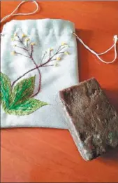  ?? PHOTOS PROVIDED TO CHINA DAILY ?? A piece of black soap and its packing bag made by Kazakh women in a soap-making workshop in Qinghe county, in the Xinjiang Uygur autonomous region.