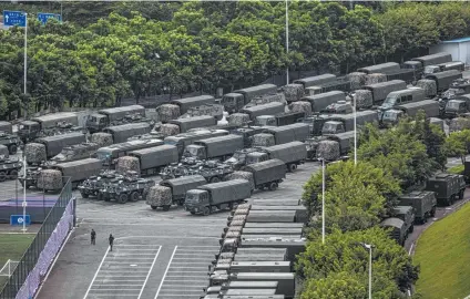  ?? Lam Yik Fei / New York Times ?? China mobilized hundreds of security officers from its paramilita­ry force People’s Armed Police in the past week to Shenzhen, China, which is across the border from Hong Kong. The military buildup comes amid protests in the city.