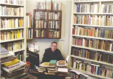  ?? PETER ELLIS BOOKSELLER ?? Peter Ellis sits at his book-stacked desk inside his eponymous antiquaria­n bookshop off London’s Charing Cross Road.