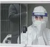  ?? THE ASSOCIATED PRESS ?? Medical staff wait in a container for the next COVID-19 test at a test centre in Cologne, Germany.