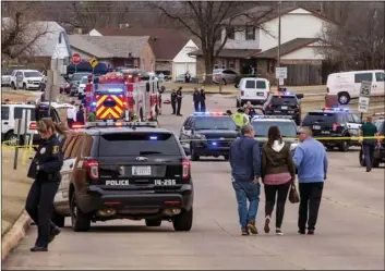  ?? CHRIS LANDSBERGE­R/THE OKLAHOMAN VIA AP ?? In this Feb. 3, 2020, file photo, emergency crews respond to a scene where a vehicle hit several Moore High School students in Moore, Okla.