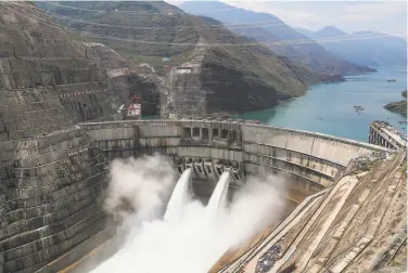  ?? China News Service / AFP via Getty Images ?? Water is released from the Baihetan Dam on the Jinsha River, a tributary of the Yangtze. The 954foottal­l dam will eventually have a power capacity second only to the Three Gorges Dam, opened by China in 2003.