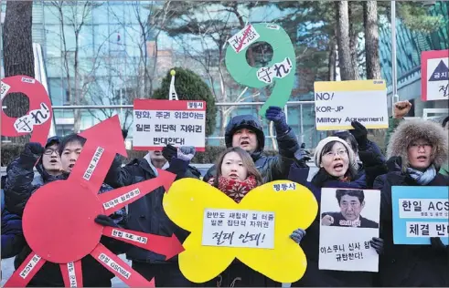  ?? WOOHAE CHO / AGENCE FRANCE-PRESSE ?? Protesters shout slogans against Japanese Prime Minister Shinzo Abe outside the Japanese embassy in Seoul on Friday. Abe paid his respects on Thursday at the controvers­ial Yasukuni Shrine in a move that drew sharp rebukes from China and South Korea,...