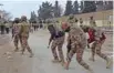  ?? - Reuters ?? STRIFE-TORN: Paramilita­ry soldiers enter the cordoned site after gunmen shot dead four soldiers in Quetta, Pakistan February 14, 2018.