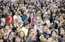  ?? JAE C. HONG/ THE ASSOCIATED PRESS ?? American flags wave during a naturaliza­tion ceremony earlier this month at the Los Angeles Convention Center. Since President Donald Trump’s immigratio­n enforcemen­t order and travel ban, immigrants have been rushing to prepare applicatio­ns for...