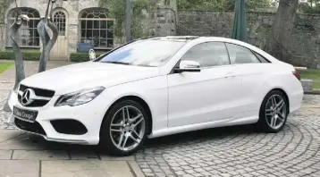  ??  ?? ALL ABOARD: The Mercedes-Benz E-Class coupe, and below, Ben and Amy with Sam the dog