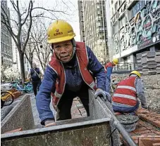  ?? /Reuters ?? Building blocks: A worker labours at a constructi­on site in Beijing on April 9. China’s industrial output in March grew 4.5% from a year earlier.